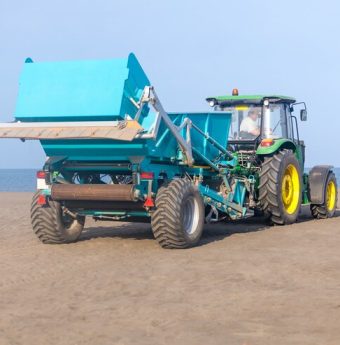 grader-bulldozer-sand-working-maltakva-beach_194646-647